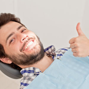 Man smiling after a successful tooth extraction